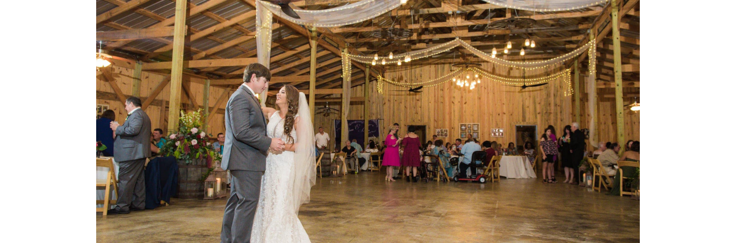 Bride and groom dancing in barn